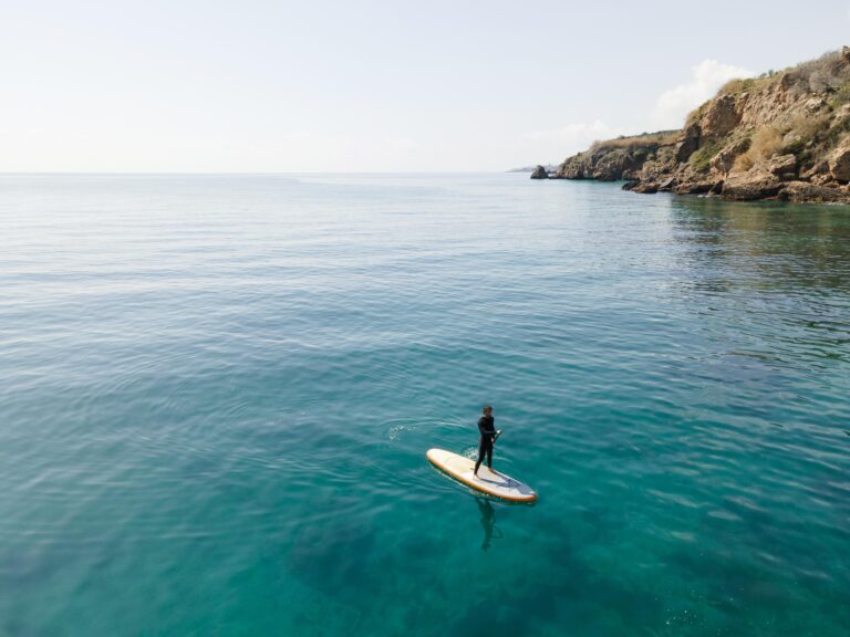 long-shot-man-surfing-with-beautiful-view